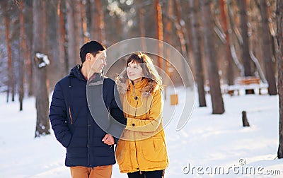 Warm winter portrait of a couple of different race in the forest Stock Photo