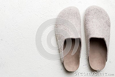 Warm winter women woolen slippers on colored background. Copy space for text Stock Photo