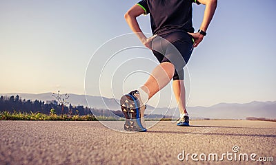 Warming up runner on the road close up image Stock Photo