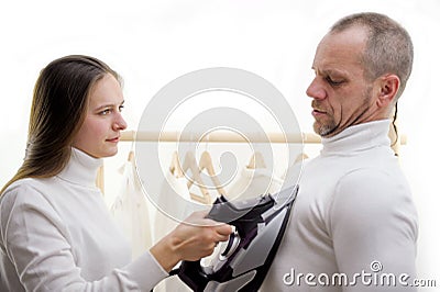 warmth in heart love relationship woman holding iron on chest head of family clothing concept of power decision severity Stock Photo