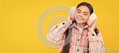 Warmth to touch. Happy child enjoy warmth of fur earmuffs. Fashion winter accessories. Child face, horizontal poster Stock Photo