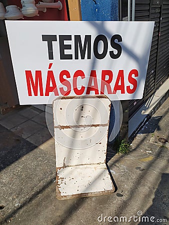 Warning banner to sell face masks during the coronavirus pandemic. Banner saying Temos Mascaras, in English We Have Masks. Editorial Stock Photo