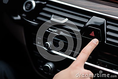 Man pressing red triangle car hazard light button Stock Photo