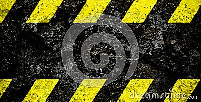 Warning danger sign yellow and black stripes pattern with black area over concrete cement wall facade peeling cracked paint. Stock Photo
