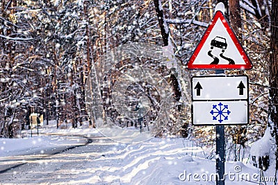 Warning due to wet, slippy road in winter snow forest Stock Photo