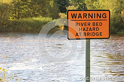 Warning River Bed Hazard at Bridge Sign Stock Photo