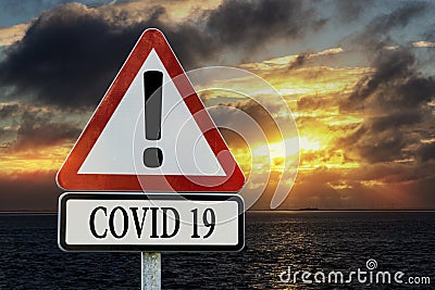 Warning road sign with text COVID-19 Stock Photo