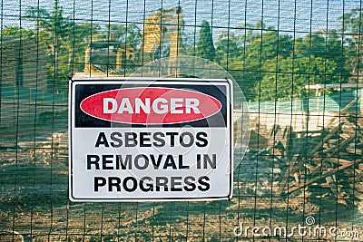 A warning sign Danger Asbestos on a fence at construction site Stock Photo