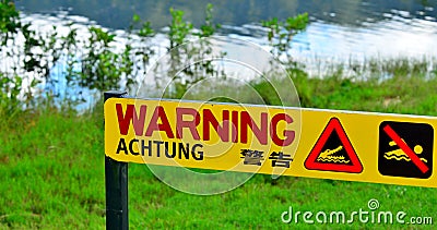 Warning sign - danger crocodiles, no swimming in Queensland, Australia Stock Photo