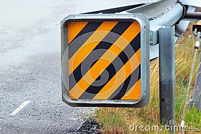 Warning sign at the end of a road guardrail Stock Photo