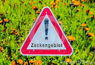 Warning sign German Zeckengebiet image Stock Photo