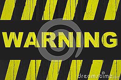 Warning sign with yellow and black stripes painted over cracked wood Stock Photo