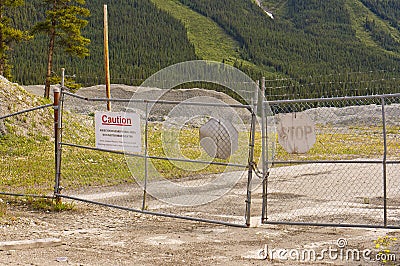 Warning signs on blocked entrance at decommissioned asbestos mine at Cassiar, BC, Canada Stock Photo