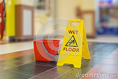 Warning yellow plastic sign of wet floor Stock Photo