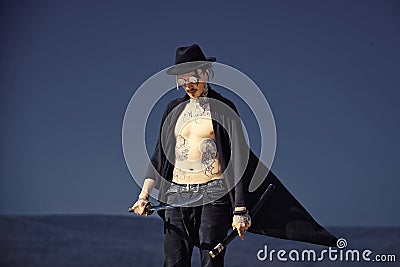 Warrior in black hat and open clothes showing tattooed torso Stock Photo