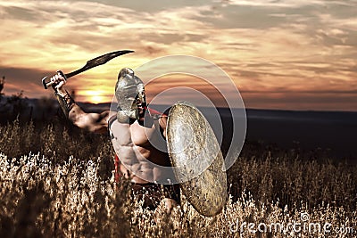 Warrior in helmet with bare torso going in attack. Stock Photo