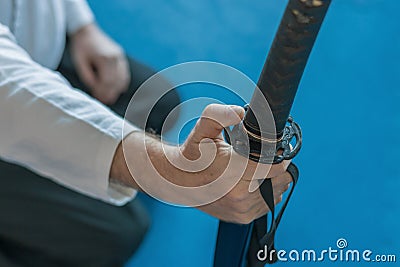 A warrior in a kimono holds a sword in his hand Stock Photo