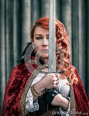 Warrior woman with sword in medieval clothes portrait Stock Photo