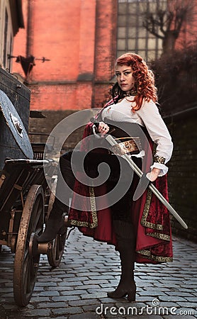 Warrior woman with sword in medieval clothes is very dangerous Stock Photo