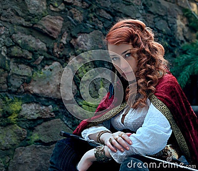 Warrior woman with sword in medieval clothes is very dangerous Stock Photo