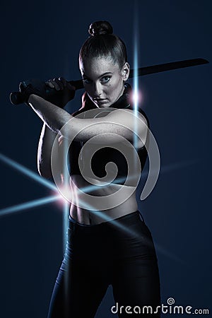 Warrior, woman and sword portrait to fight in studio for action on dark background. Strong female model, assassin or Stock Photo