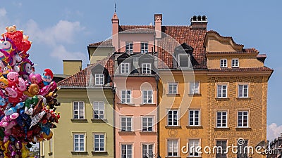 Warsaw, Poland, June, 2018: Colorful houses at old city square with cartoon balloons Editorial Stock Photo