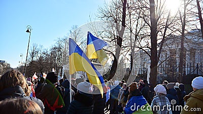 Anti-war protest outside Russian embassy in Warsaw. Demonstrators call for peace and condemn Putin. Editorial Stock Photo