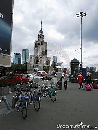 Warsaw, Poland : Wide angle shot of urban city with bicycle riding bike on rent docking station against famous Editorial Stock Photo