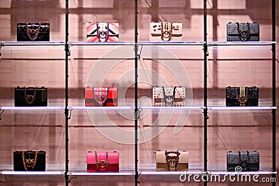 Women`s fashion accessories. Collection of handbags in a women`s store. Pinko store. Editorial Stock Photo