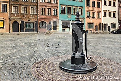 WARSAW, POLAND - MAY 12, 2012: Old vintage pump in the Warsaw Old Town Market Place Rynek Starego Miasta. Editorial Stock Photo