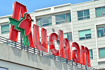 Sign Auchan. Company signboard Auchan. Editorial Stock Photo