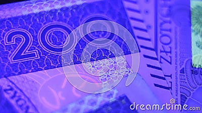 Warsaw, Poland 01.01.2021 Polish Zloty banknote under the UV counterfeit testing Editorial Stock Photo