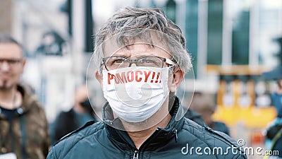 Warsaw, Poland, 05.07.2020. - Protest of the Entrepreneurs. Portrait of a man with facemask with written HELP Editorial Stock Photo