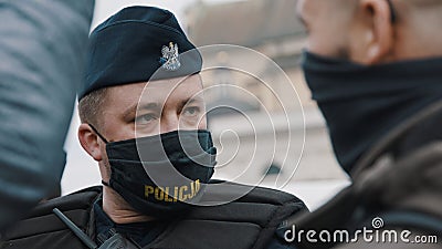 Warsaw, Poland 05.16.2020. - Protest of the Entrepreneurs. Portrait of the police officer with face masks safeguarding Editorial Stock Photo