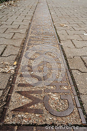 Warsaw, Poland - September 20,2021. Sign on ground where the wall of the Jewish Warsaw ghetto was located during the World War Editorial Stock Photo