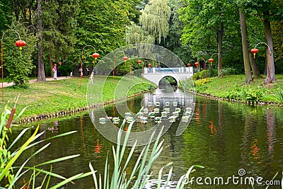 WARSAW, POLAND. A view of the channel with the Chinese small lamps ashore in the Lazenki park Editorial Stock Photo