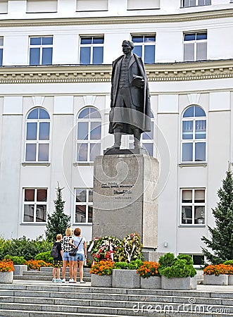 WARSAW, POLAND. Vintsenta Vitosu`s monument against the background of the building Editorial Stock Photo