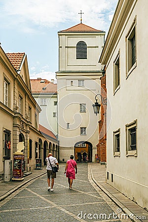 Warsaw's Old Town. Small street with walking tourists Editorial Stock Photo