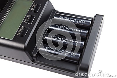 Warszawa, Poland March 4 2020:Charger on a white background PANASONIC ENELOOP BQ CC65 LCD.Photo of a black smart battery charger w Editorial Stock Photo