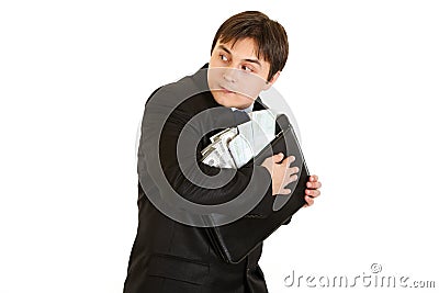 Wary businessman hugging briefcase with money Stock Photo