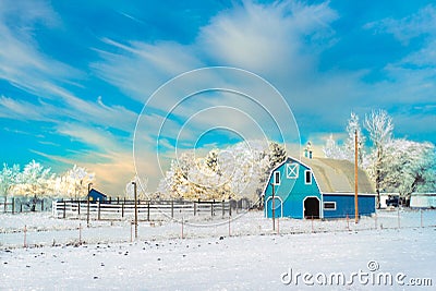 Country image of frosty blue barn. and trees after a big snowfall with cool air clouds Stock Photo