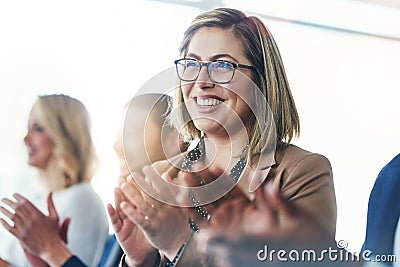 That was a good meeting. a group of businesspeople clapping hands while sitting in a meeting. Stock Photo