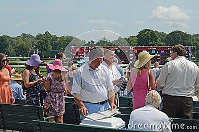 August 17, 2015, The Saratoga Race Course, Saratoga Springs, New York. A Visitor Checking The Racing Form At The August Races At Editorial Stock Photo