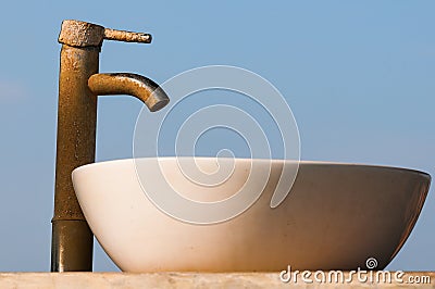 Washbasin and tap covered by limescale Stock Photo