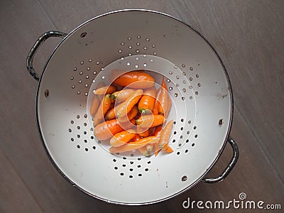 Washed carrots in a collander Stock Photo