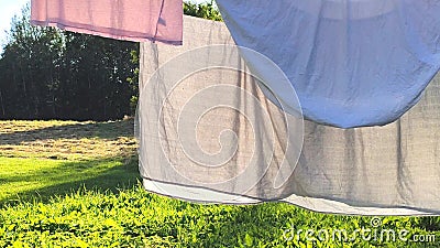Washed clean laundry hanging on the rope or clothesline drying in the wind outdoors Stock Photo
