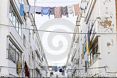 Washed clothes hanging between residencial buildings in Ayamonte, Spain Editorial Stock Photo