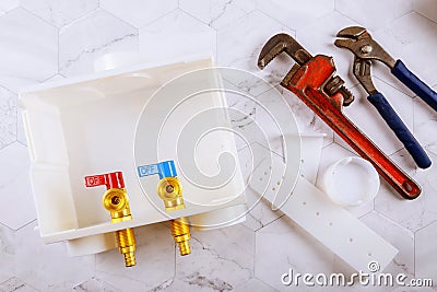 Washer dual drain outlet box and adjustable monkey wrench Stock Photo