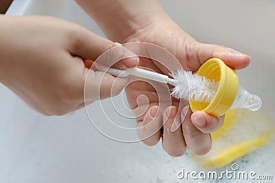 Washing baby nipples. Mother`s hand washing the baby nipples Stock Photo