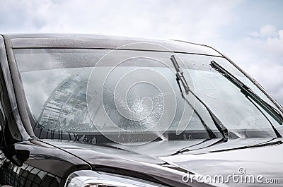 Washing car windscreen with wipers and liquid Stock Photo